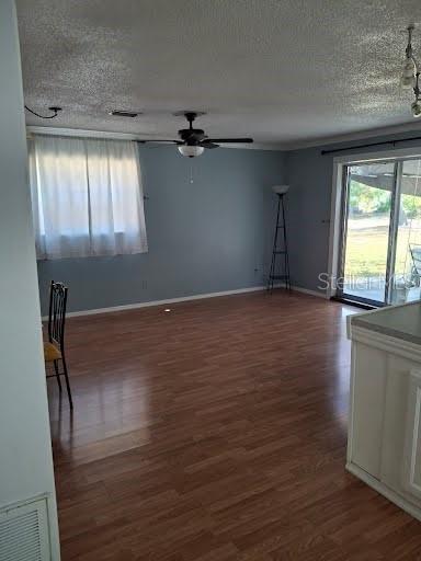 9723 Tom Street Hudson, FL 34669 - Photo 6 of 10 an empty room with wooden floor and windows