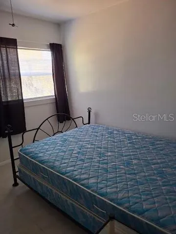 a bed sitting in a room next to a window