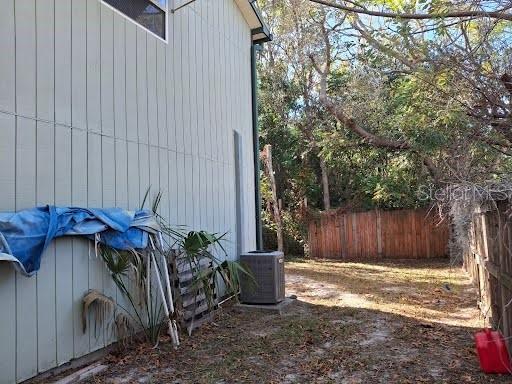 9723 Tom Street Hudson, FL 34669 - Photo 9 of 10 a view of a backyard with plants and large tree