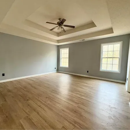a spacious bathroom with a double vanity sink and mirror