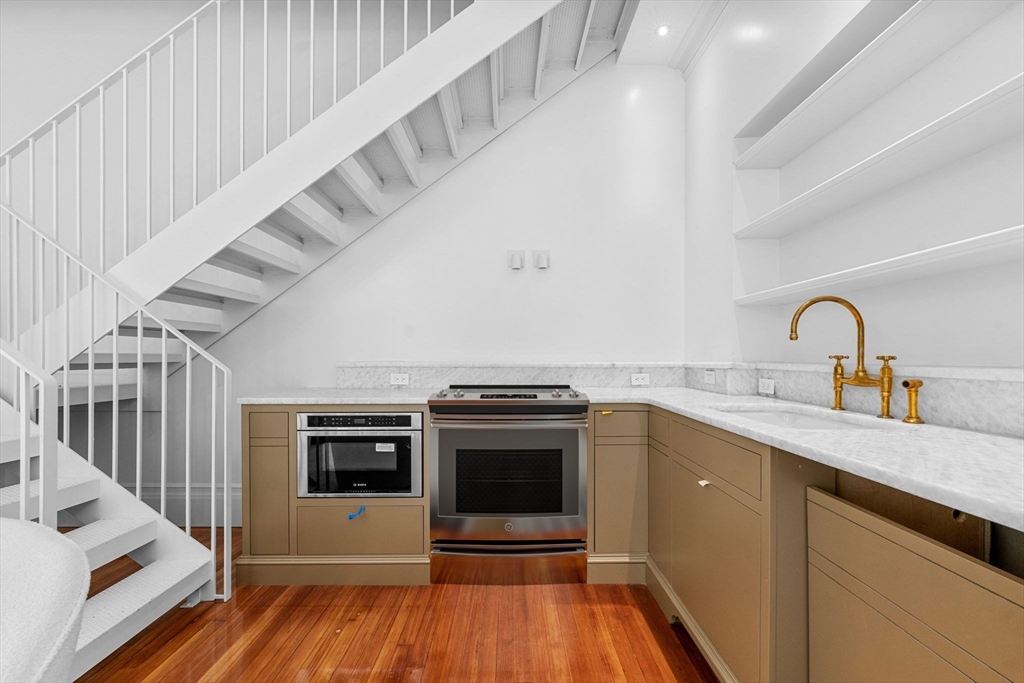 320 Tappan Street, Unit 1 Brookline, MA 02445 - Photo 4 of 10 a kitchen with a sink stainless steel appliances and cabinets