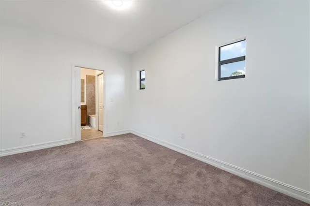a living room with furniture a rug and a window
