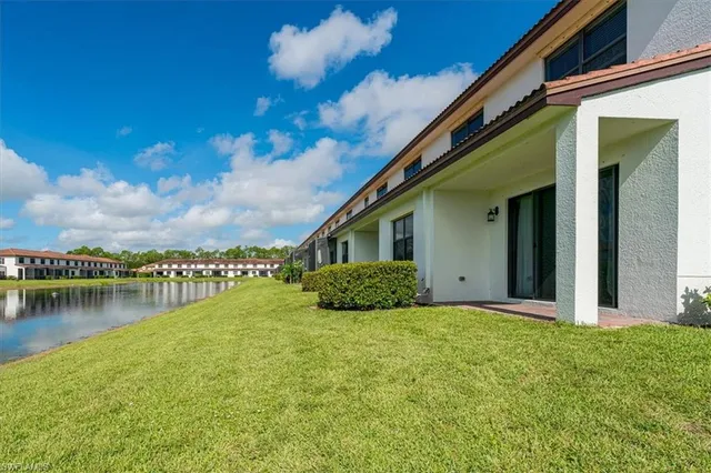 a view of a house with swimming pool and a yard