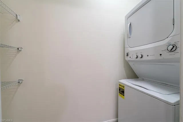 a kitchen with stainless steel appliances granite countertop white cabinets and refrigerator