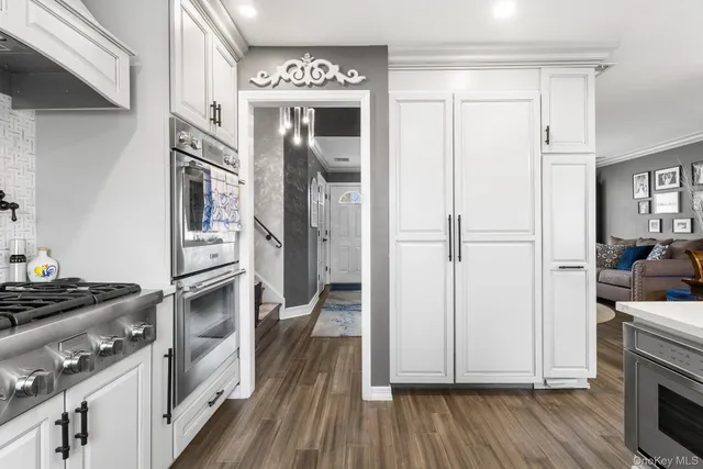 a kitchen with cabinets and wooden floor