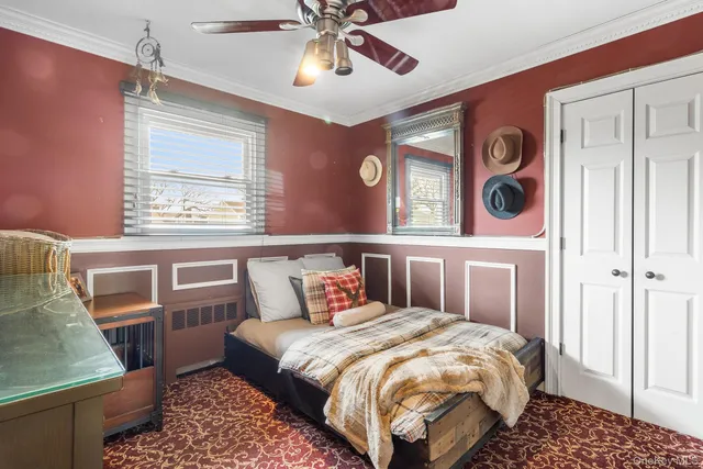 a bedroom with a large bed and a window