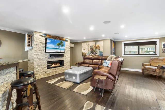 a living room with fireplace furniture and a flat screen tv