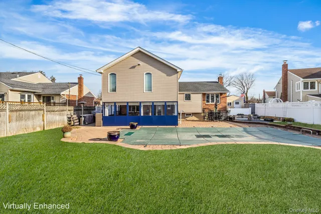 a view of a house with a yard and sitting area