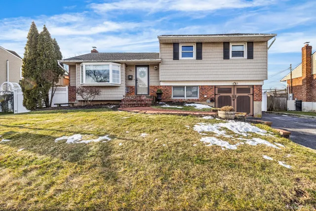 a view of a house with a swimming pool and sitting area