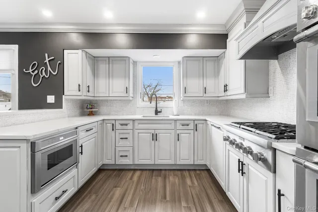 a kitchen with granite countertop white cabinets and white appliances