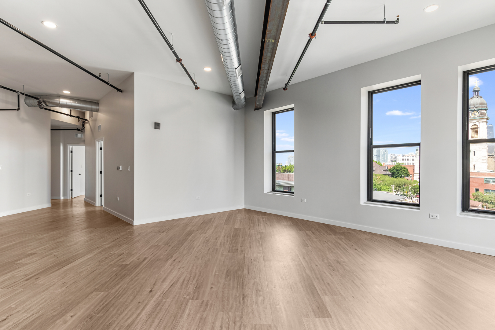 805 North Milwaukee Avenue, Unit 4N Chicago, IL 60642 - Photo 11 of 34 an empty room with wooden floor and windows