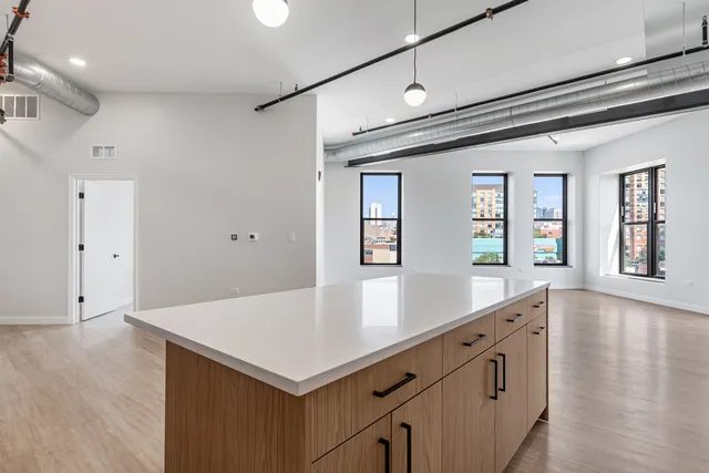 a view of kitchen island with wooden floor and window