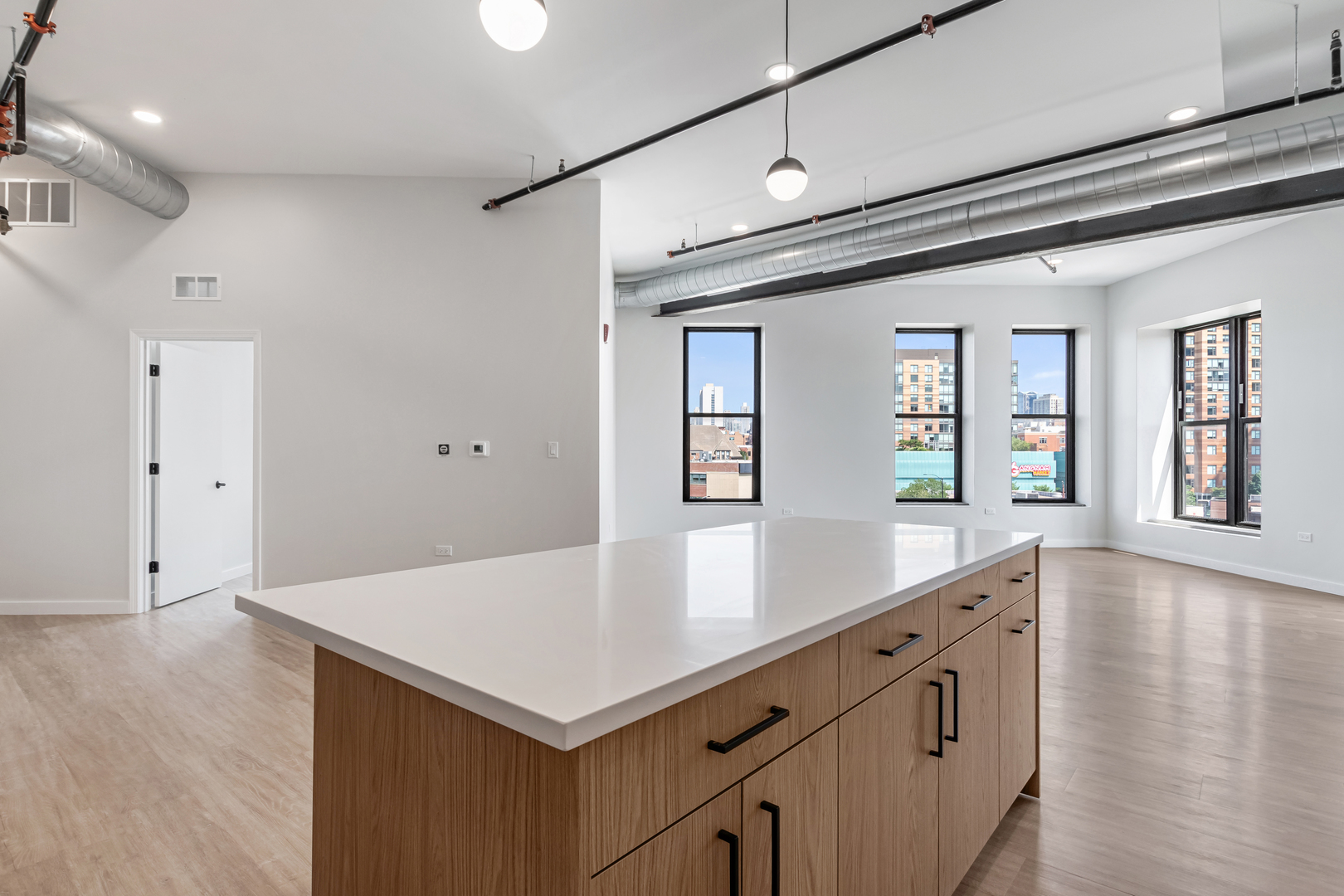 805 North Milwaukee Avenue, Unit 4N Chicago, IL 60642 - Photo 12 of 34 a view of kitchen island with wooden floor and window