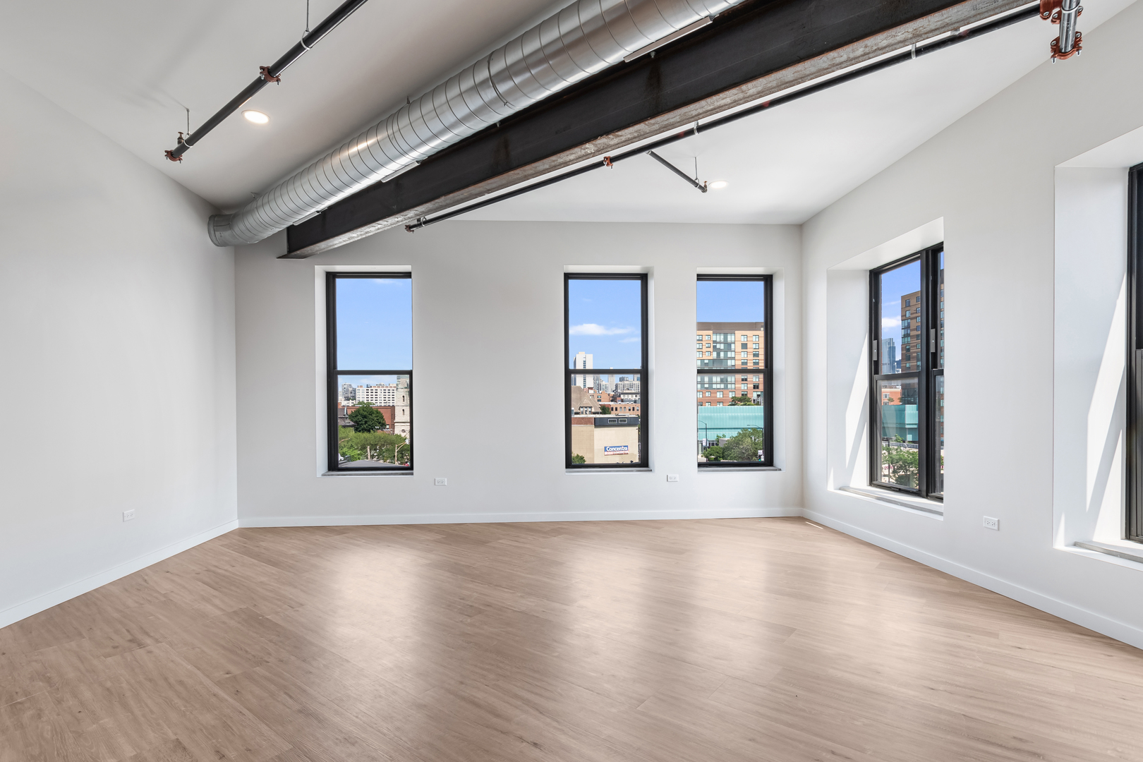 805 North Milwaukee Avenue, Unit 4N Chicago, IL 60642 - Photo 13 of 34 a view of an empty room with wooden floor and a window