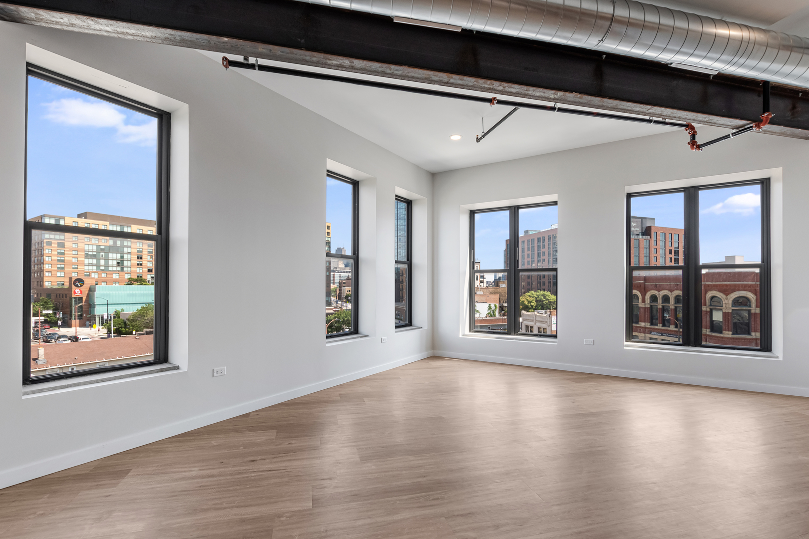 805 North Milwaukee Avenue, Unit 4N Chicago, IL 60642 - Photo 14 of 34 a view of an empty room with window and wooden floor
