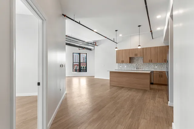 a spacious bathroom with a large mirror vanity and a shower