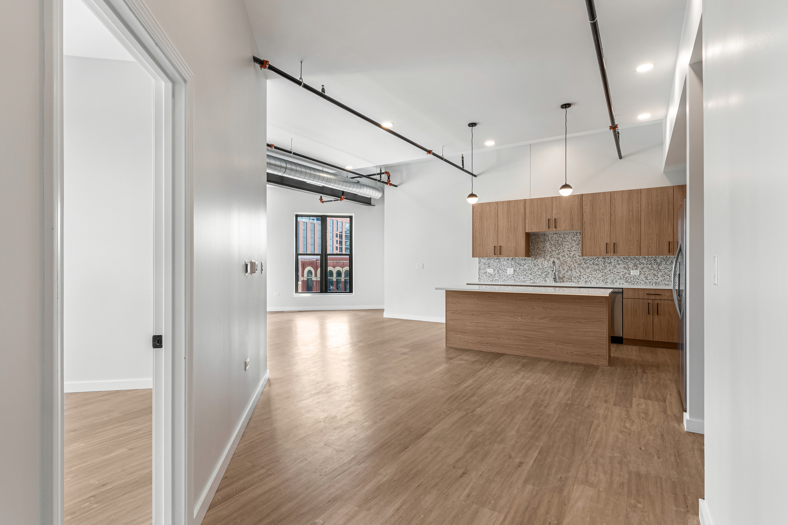 805 North Milwaukee Avenue, Unit 4N Chicago, IL 60642 - Photo 15 of 34 a spacious bathroom with a large mirror vanity and a shower