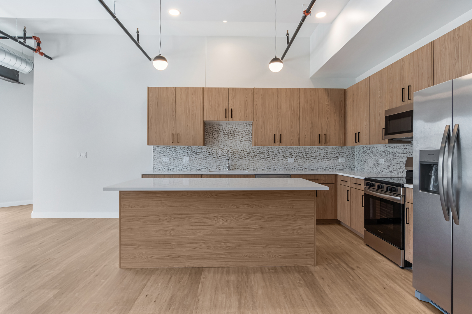 805 North Milwaukee Avenue, Unit 4N Chicago, IL 60642 - Photo 2 of 34 a kitchen with a wooden floor and a refrigerator