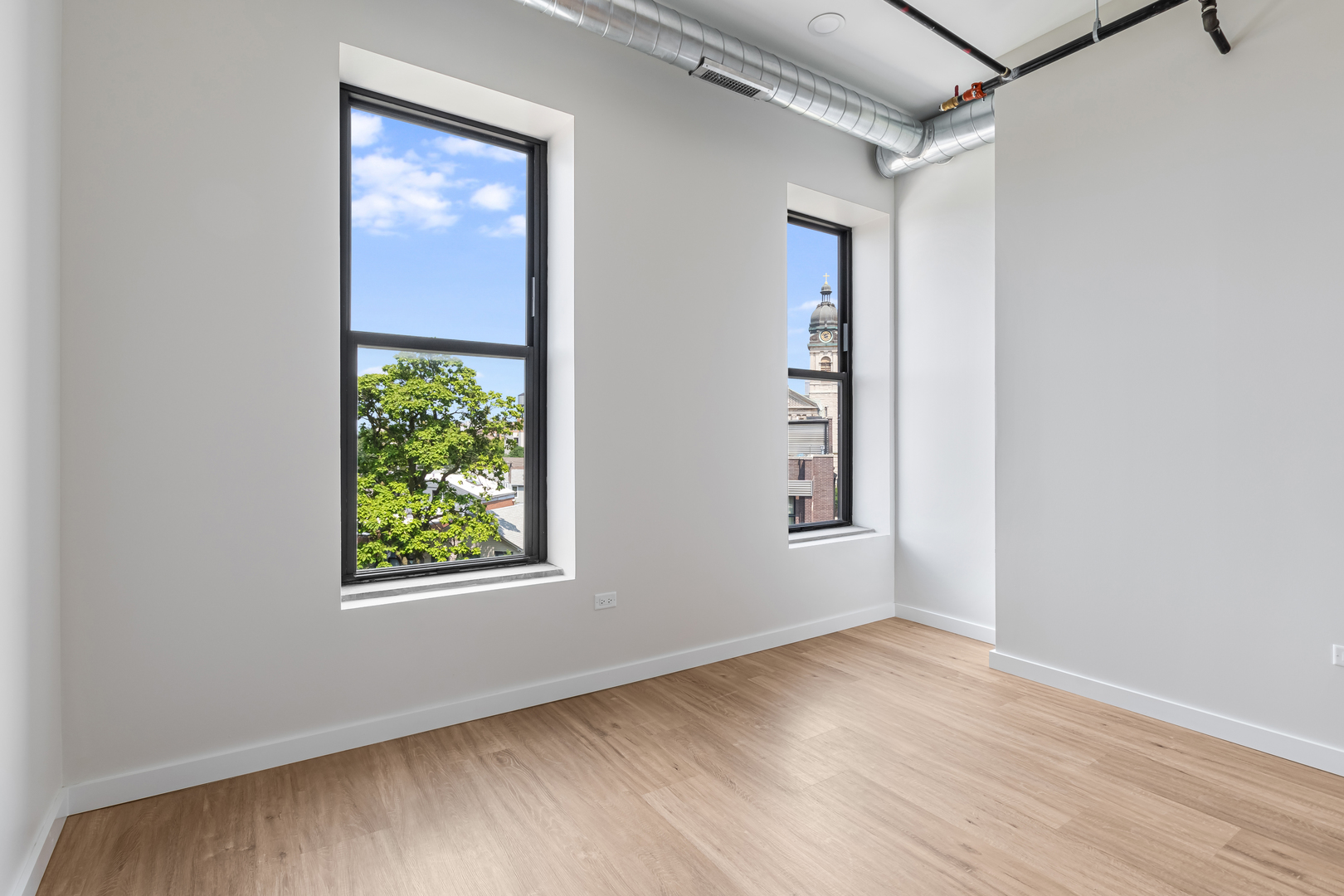 805 North Milwaukee Avenue, Unit 4N Chicago, IL 60642 - Photo 22 of 34 an empty room with wooden floor and windows