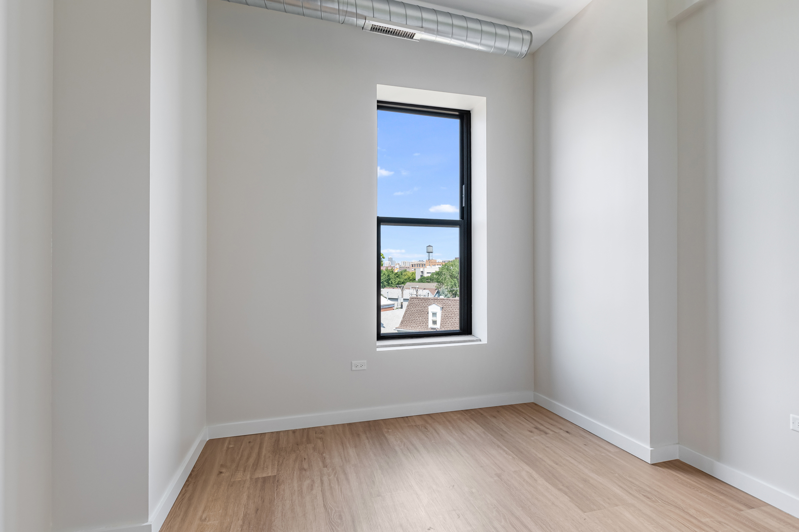 805 North Milwaukee Avenue, Unit 4N Chicago, IL 60642 - Photo 23 of 34 an empty room with wooden floor and windows