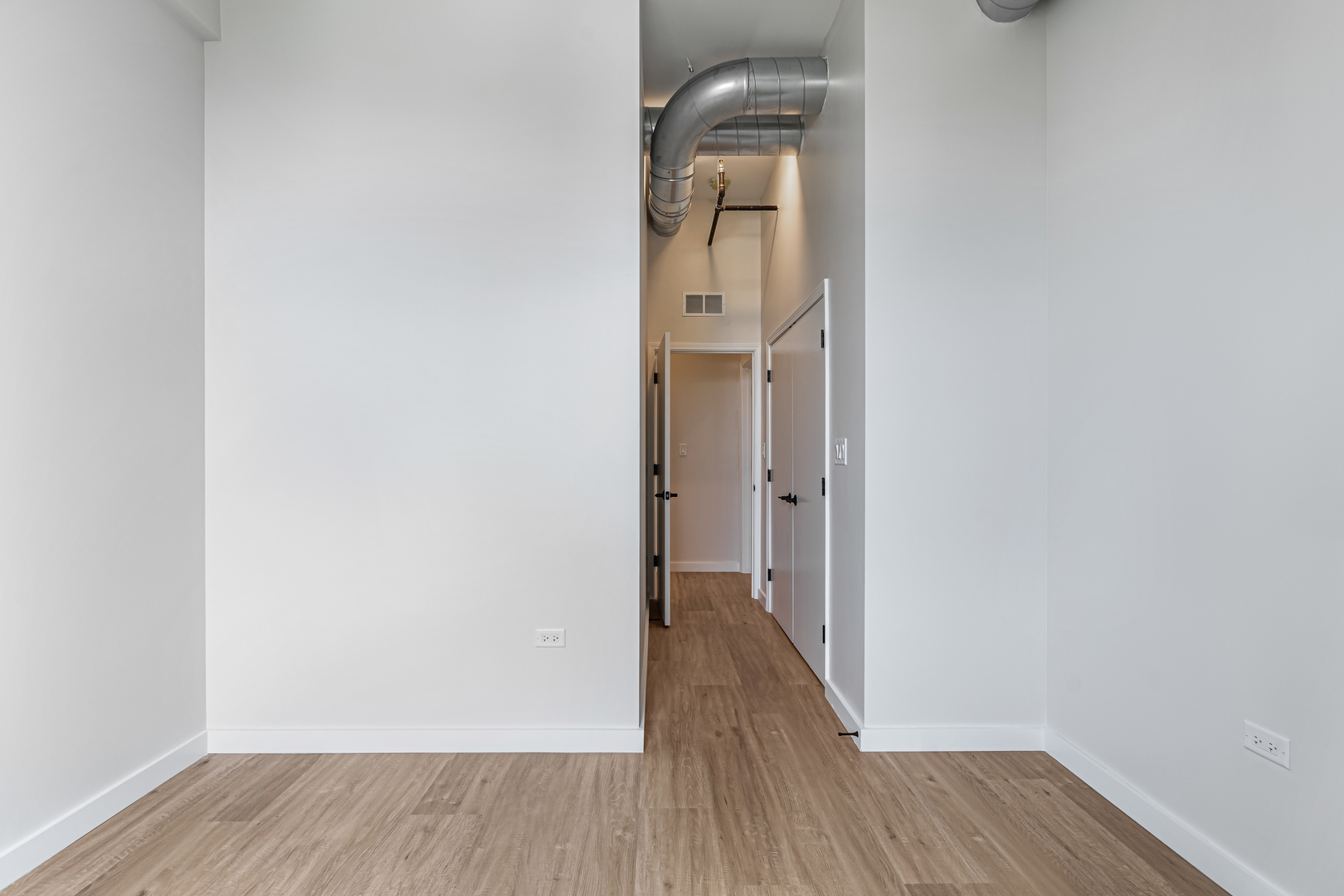 805 North Milwaukee Avenue, Unit 4N Chicago, IL 60642 - Photo 24 of 34 a view of a room with wooden floor and mirror