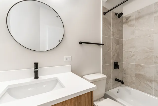 a bathroom with a sink a toilet and a mirror