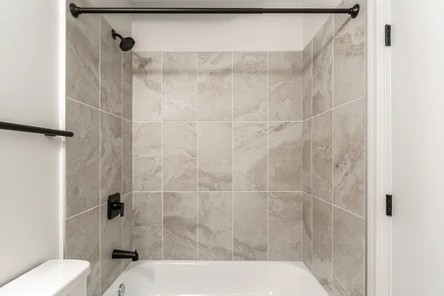 a bathroom with a toilet and shower