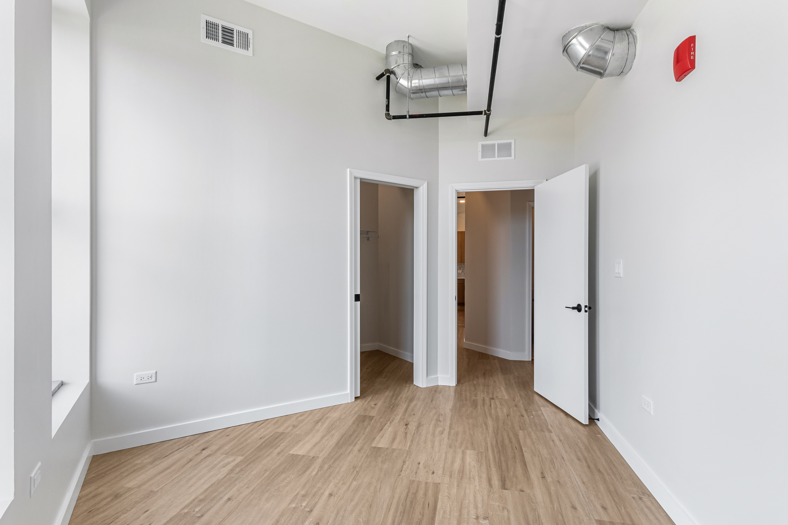 805 North Milwaukee Avenue, Unit 4N Chicago, IL 60642 - Photo 30 of 34 a view of a hallway with wooden floor