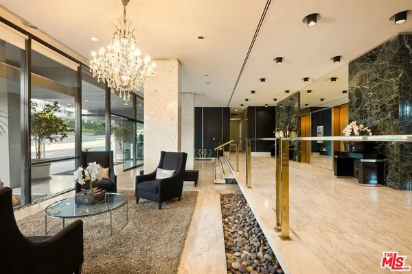 a lobby with furniture and a chandelier