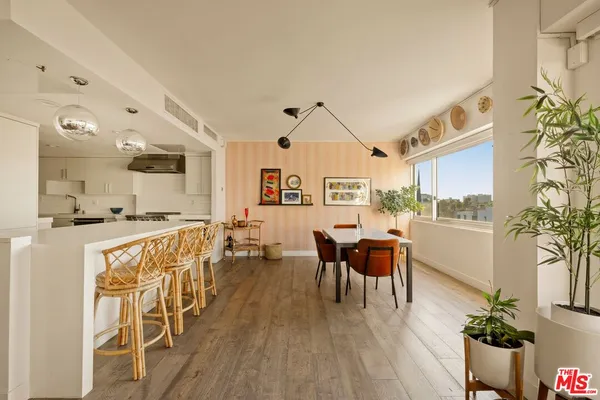 a dining room with furniture window and wooden floor