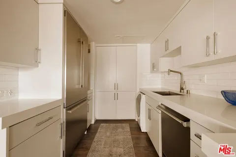 a kitchen with a sink and a refrigerator