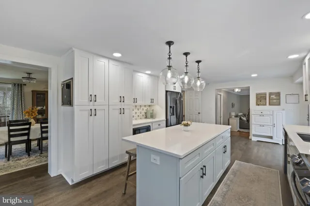 a kitchen with a refrigerator a sink and a wooden cabinets