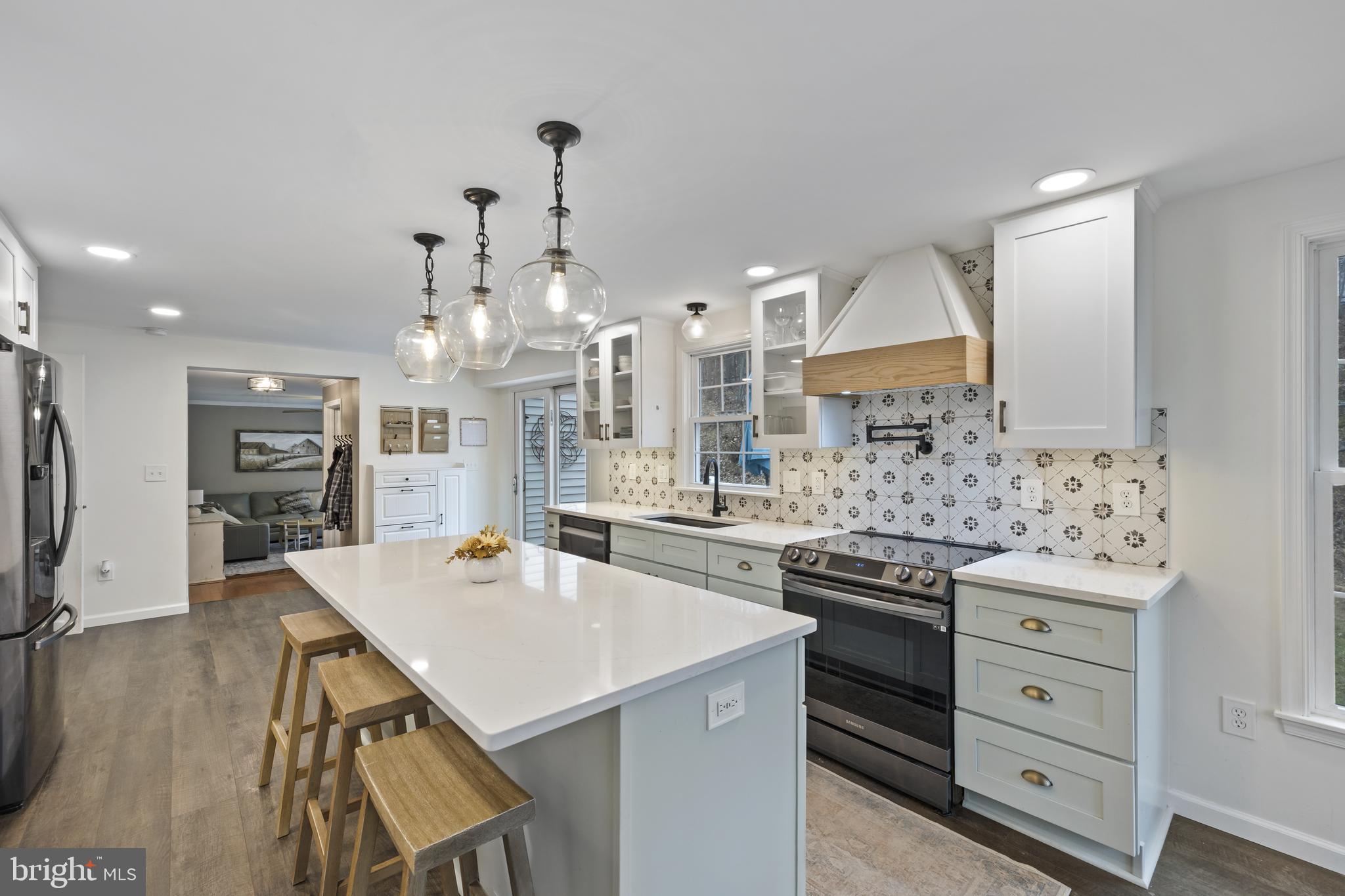 7802 Blue Hill Road Glenville, PA 17329 - Photo 17 of 44 a kitchen with stainless steel appliances a stove a sink dishwasher and a refrigerator with wooden floor