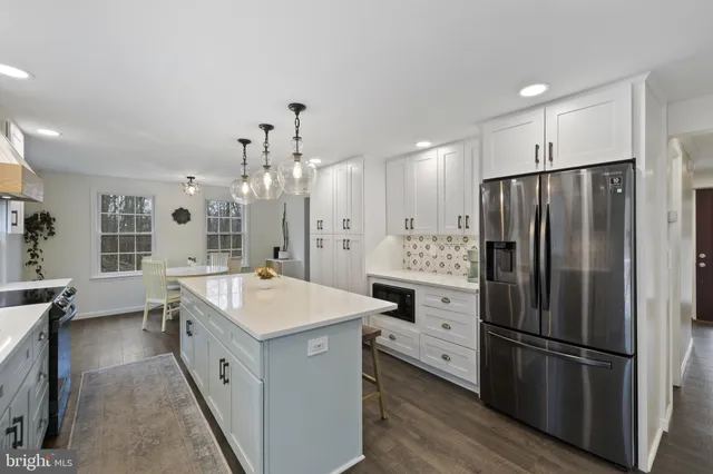 a kitchen with kitchen island a sink stove and refrigerator