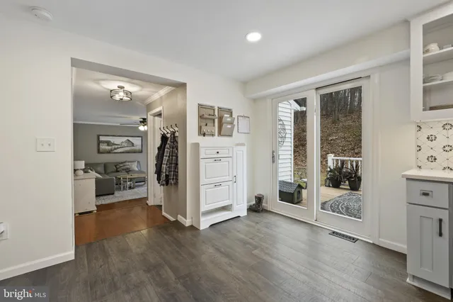 a view of a livingroom with wooden furniture and windows