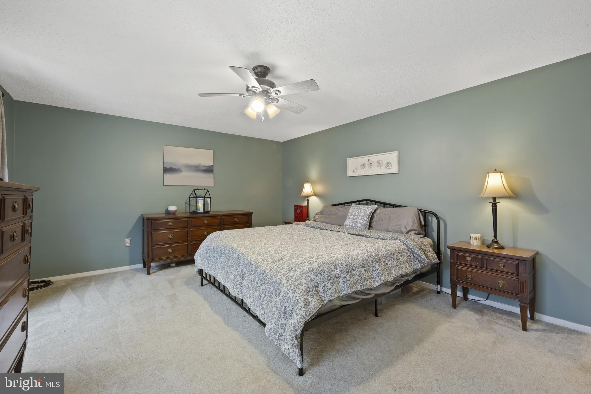 7802 Blue Hill Road Glenville, PA 17329 - Photo 31 of 44 a spacious bedroom with a bed and a chandelier