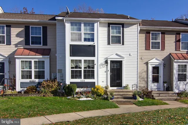 a front view of a house with garden and porch