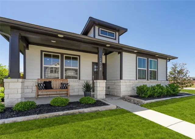 a front view of a house with garden and porch