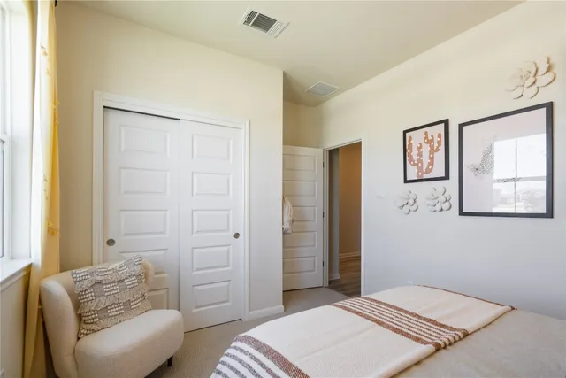 a bedroom with a bed and couch