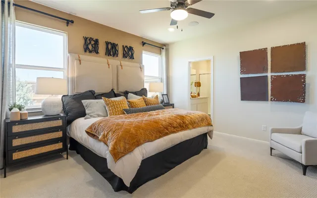 a spacious bedroom with a bed and lamp