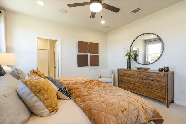 a bedroom with a large bed and a chandelier