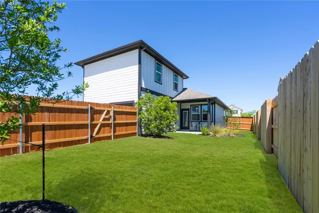 a view of a house with a yard and sitting area
