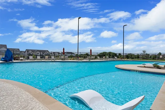 a view of a garden with lawn chairs