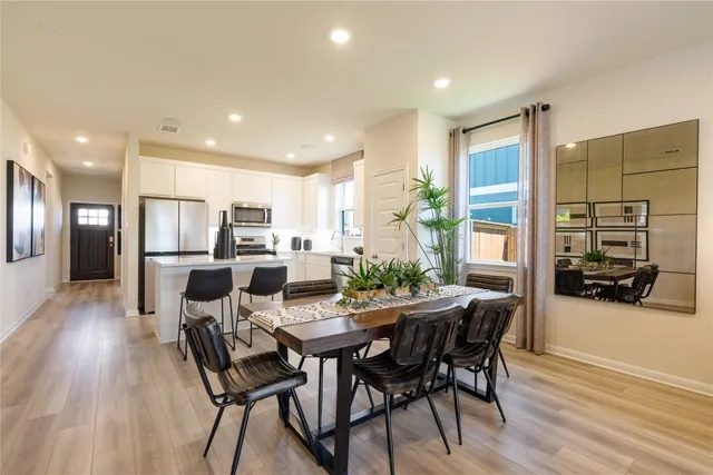 a view of a dining room with furniture and wooden floor
