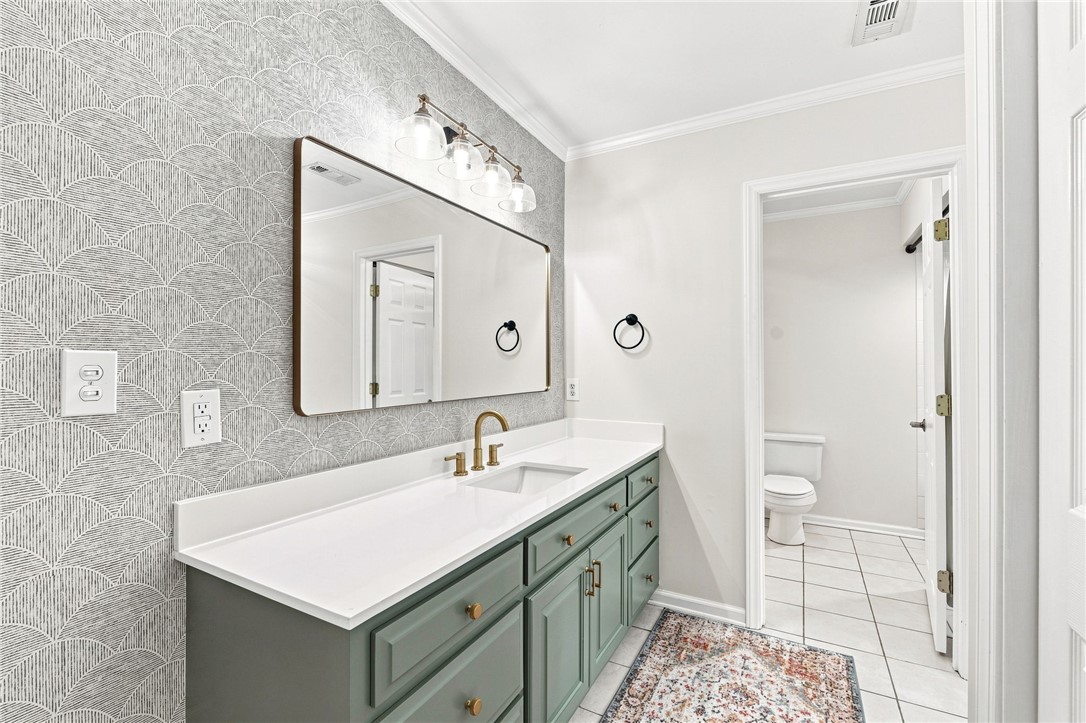 320 Watson Road Easley, SC 29642 - Photo 29 of 50 Textured wall coverings and modern fixtures elevate this updated vanity area.