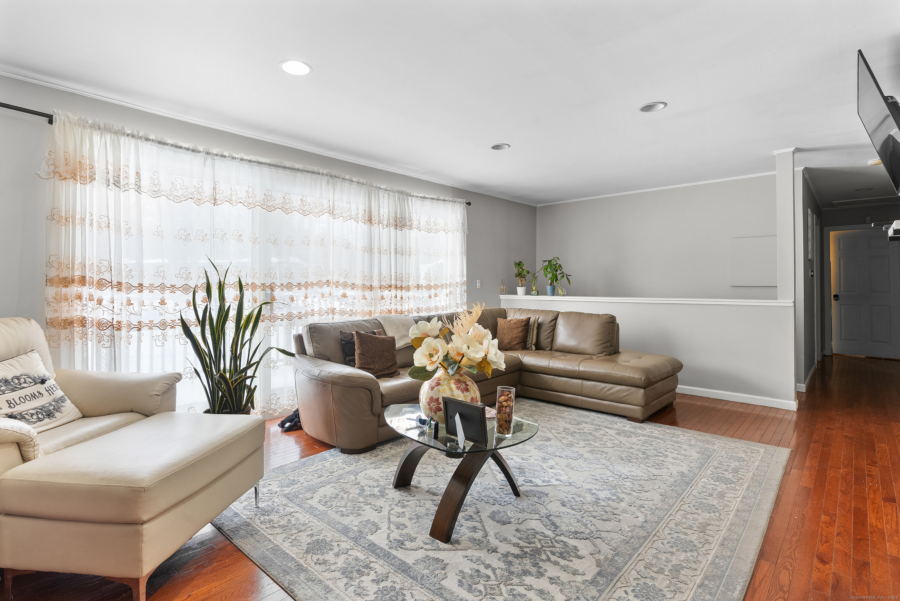 8 Stonecrop Road North Norwalk, CT 06851 - Photo 1 of 15 a living room with furniture a rug and a chandelier