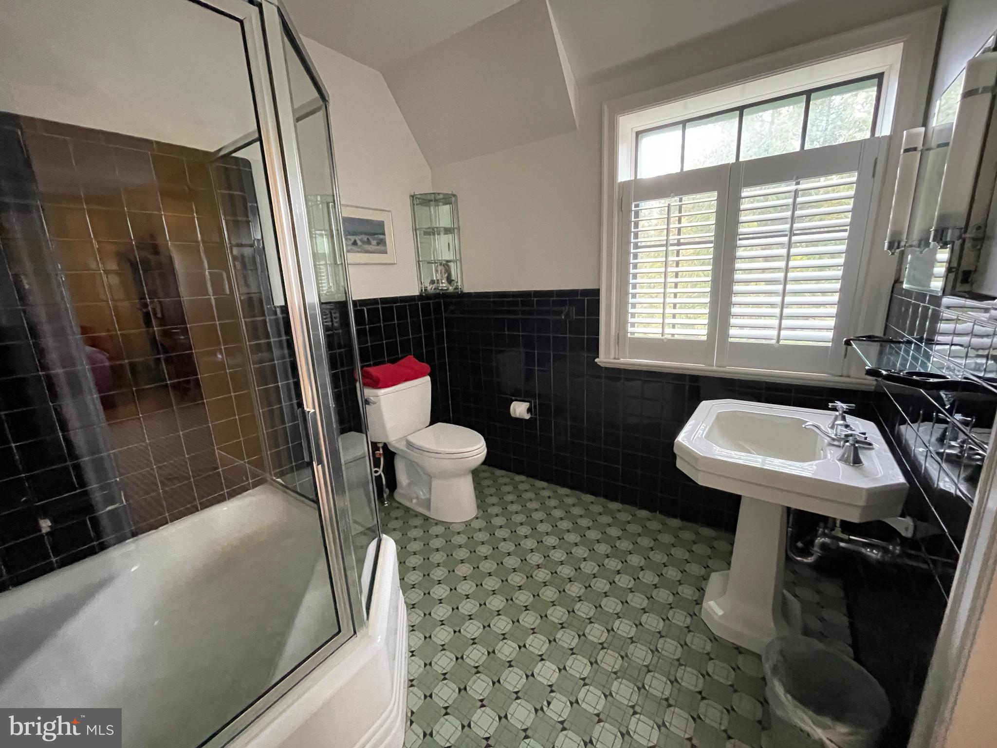 3117 Chain Bridge Road Northwest Washington, DC 20016 - Photo 15 of 26 Stylish tiled bath, commodious bathtub.
