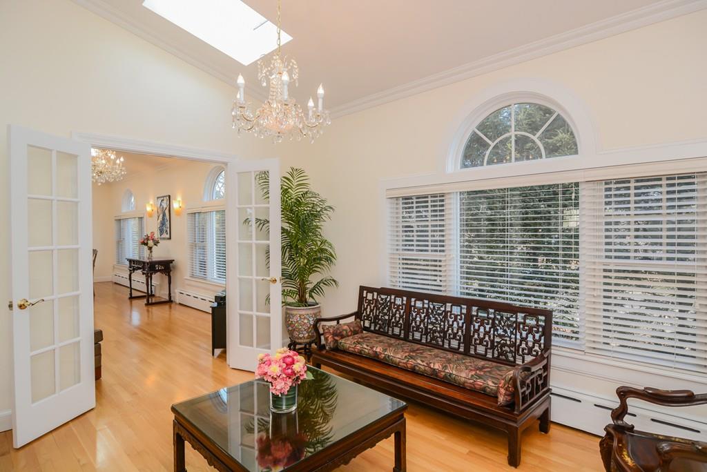 7 Benjamin Road Lexington, MA 02421 - Photo 12 of 42 a living room with furniture and a chandelier
