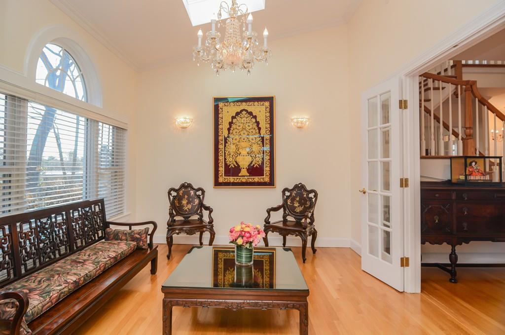 7 Benjamin Road Lexington, MA 02421 - Photo 13 of 42 a living room with furniture a chandelier and a dining table