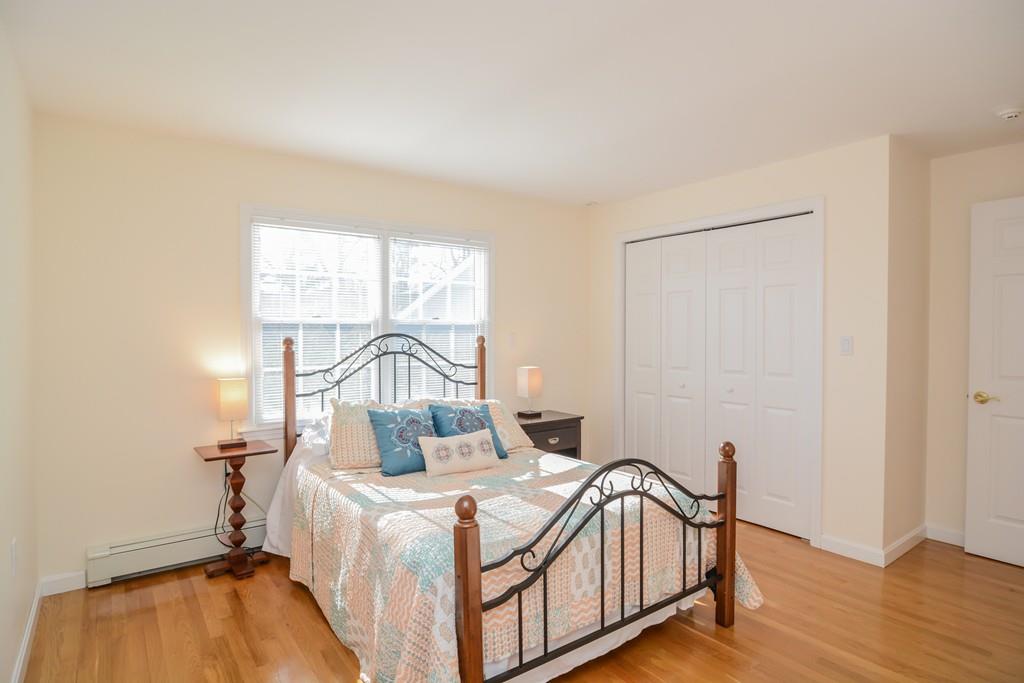 7 Benjamin Road Lexington, MA 02421 - Photo 22 of 42 a bedroom with a bed and wooden floor